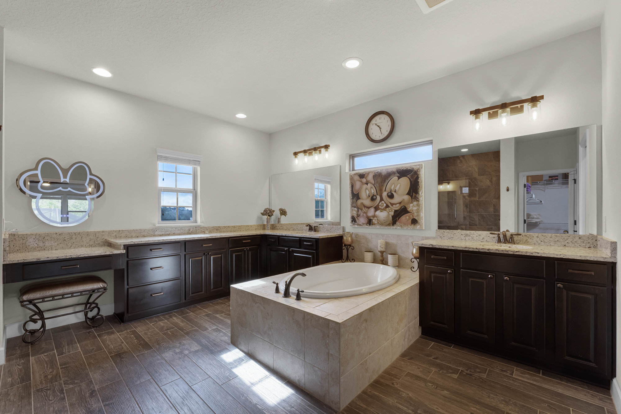 large bathroom with double sink cabinets and tub